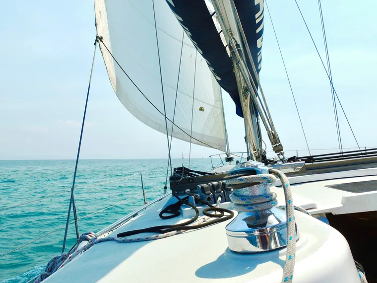 Sails of a yacht over turquoise water