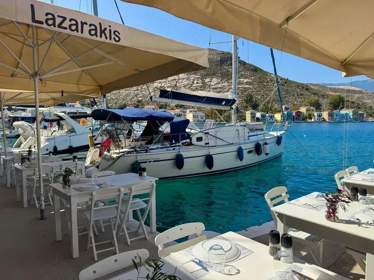 Yachts moored by a Greek taverna